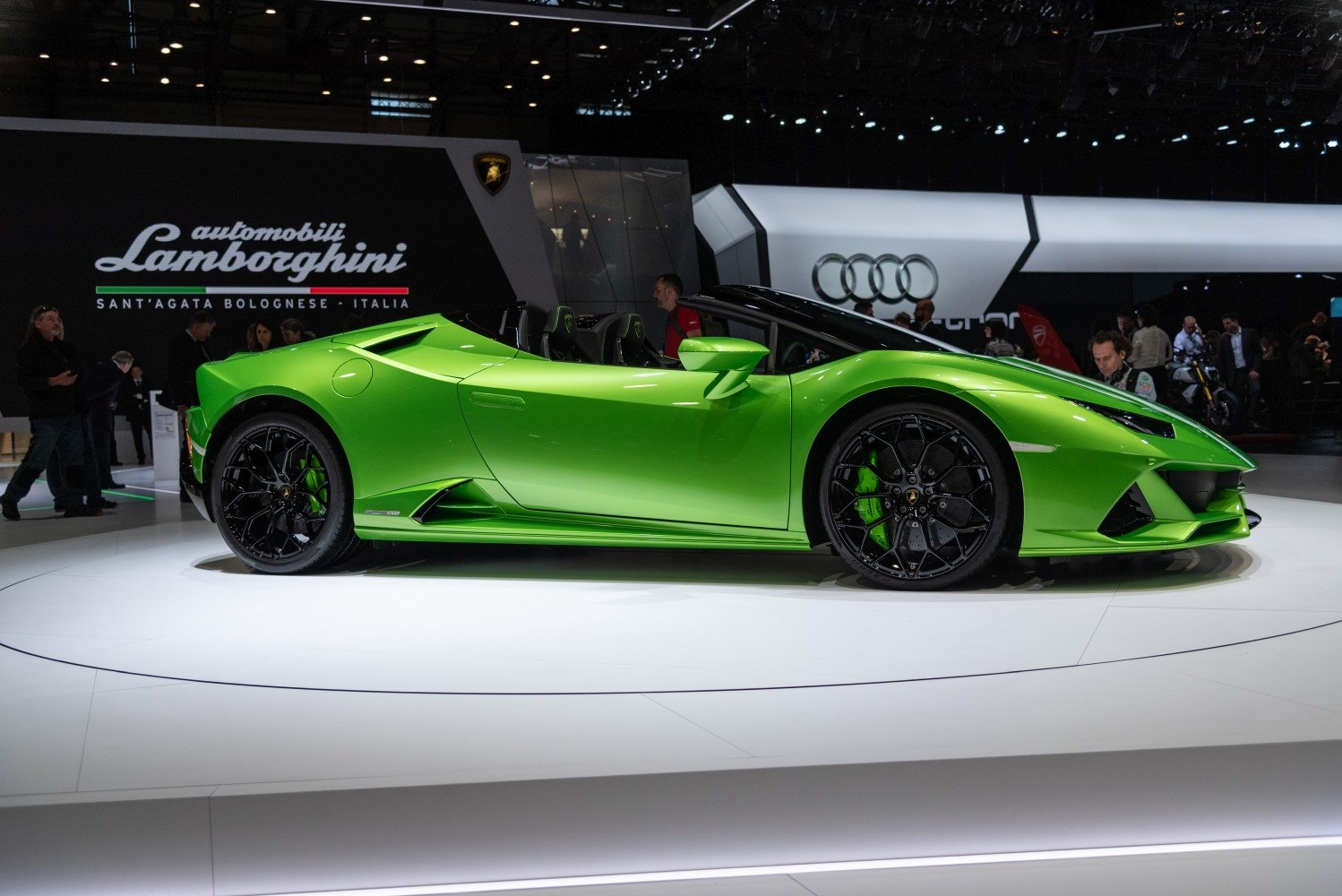 Green convertible sports car with aggressive aerodynamic design and black wheels