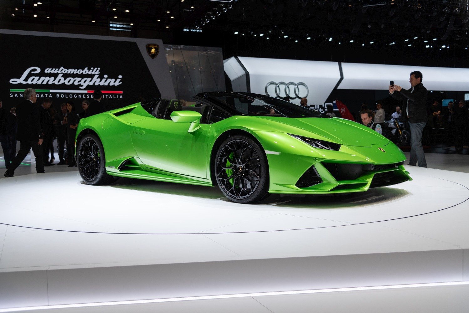 Bright green convertible sports car with black wheels
