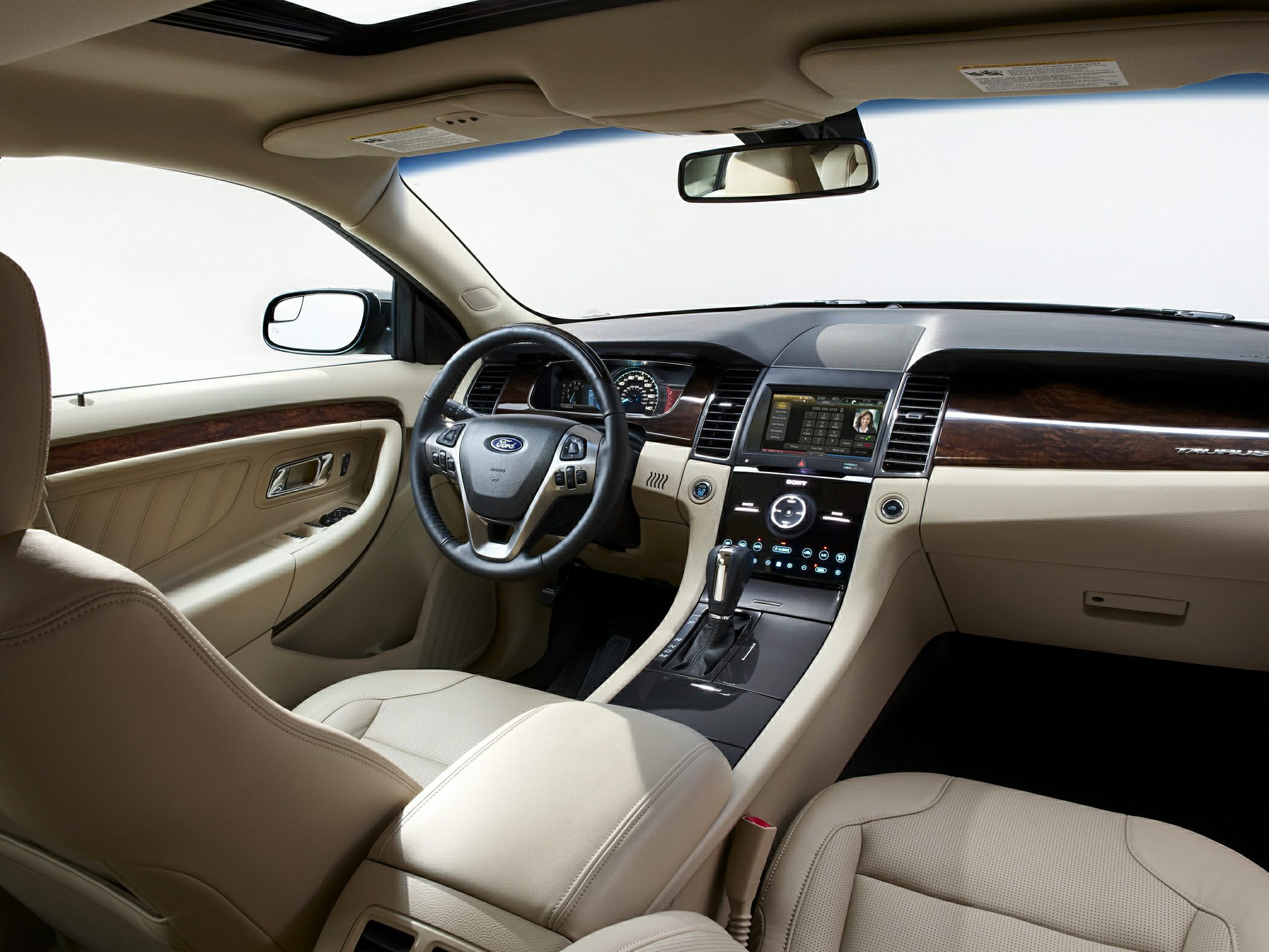 Beige leather seats, wood trim dashboard, touchscreen infotainment center