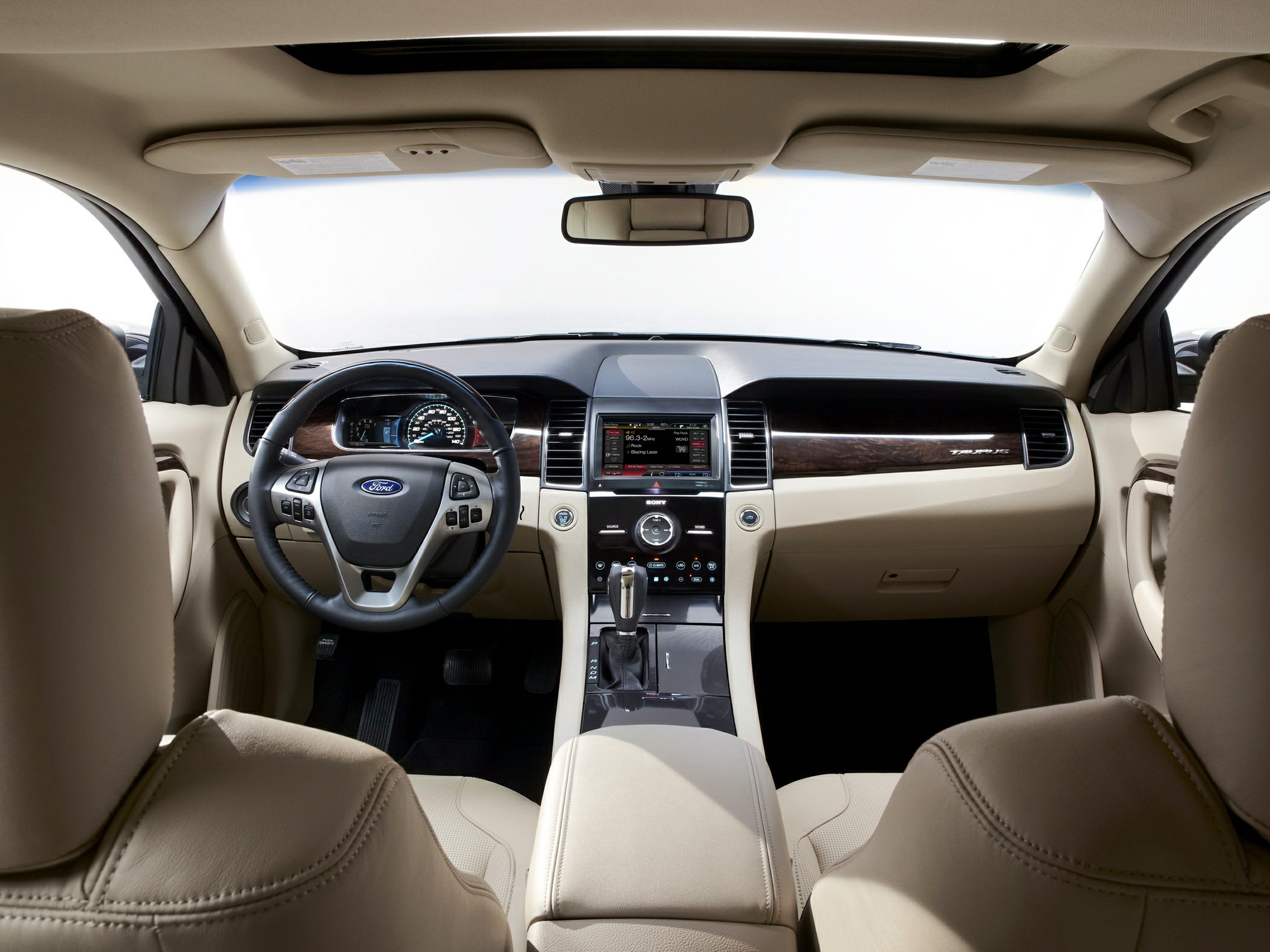 Beige car interior with dashboard, steering wheel, and center console