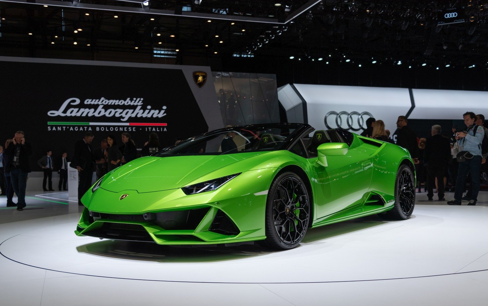 Green sports convertible with sharp LED headlights and open-top design.