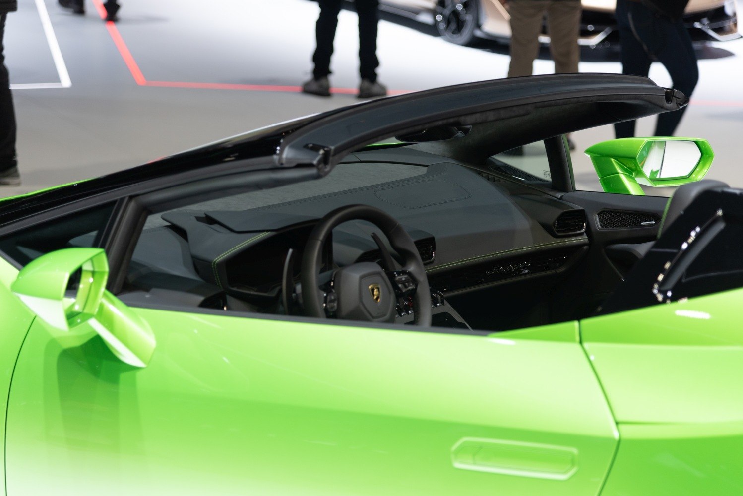 Convertible luxury sports car interior with sleek dashboard and side mirror