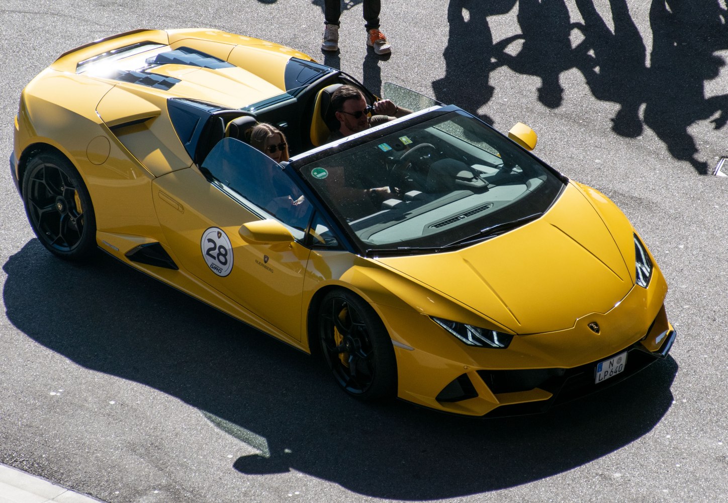 Yellow convertible Lamborghini with aerodynamic design and black wheels