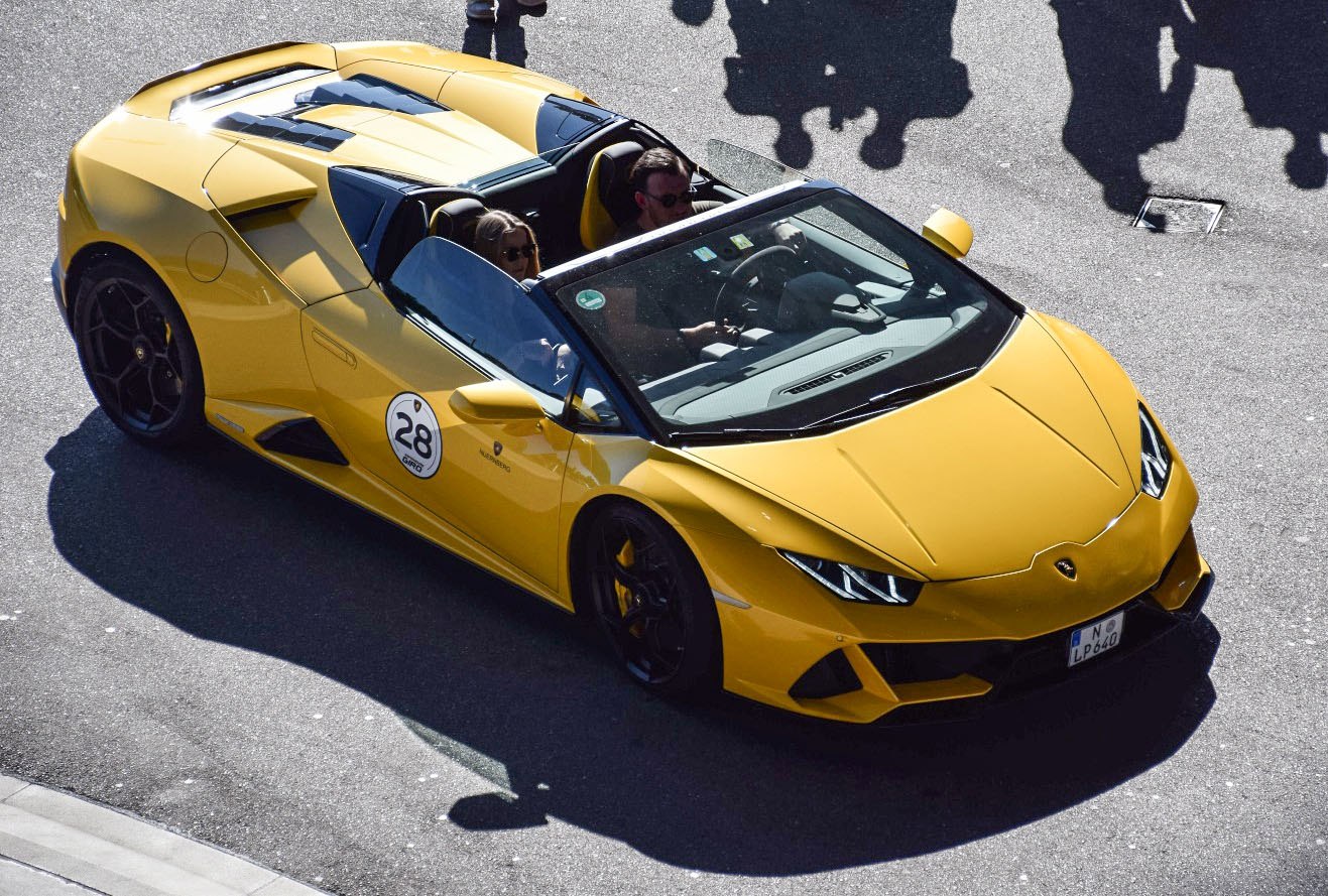 Yellow convertible with sharp headlights and aerodynamic design
