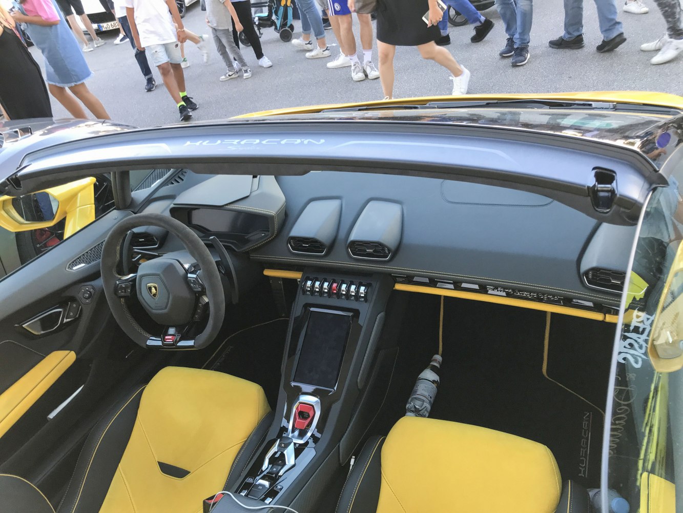 Luxury sports car interior with yellow and black seats and advanced cockpit design