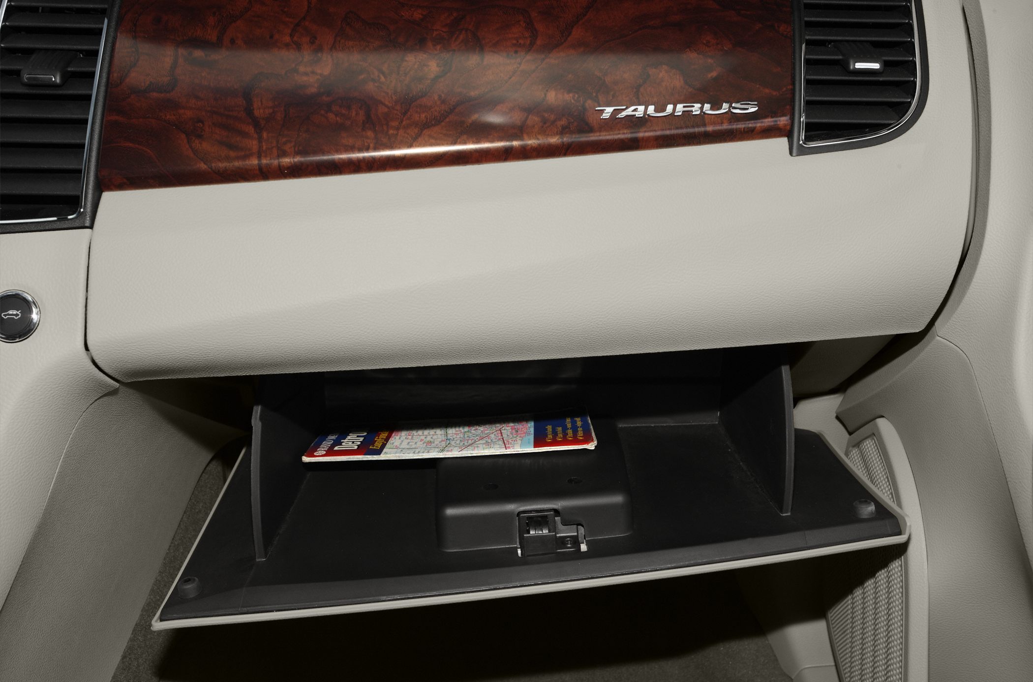 Glove box with wood grain trim and beige interior