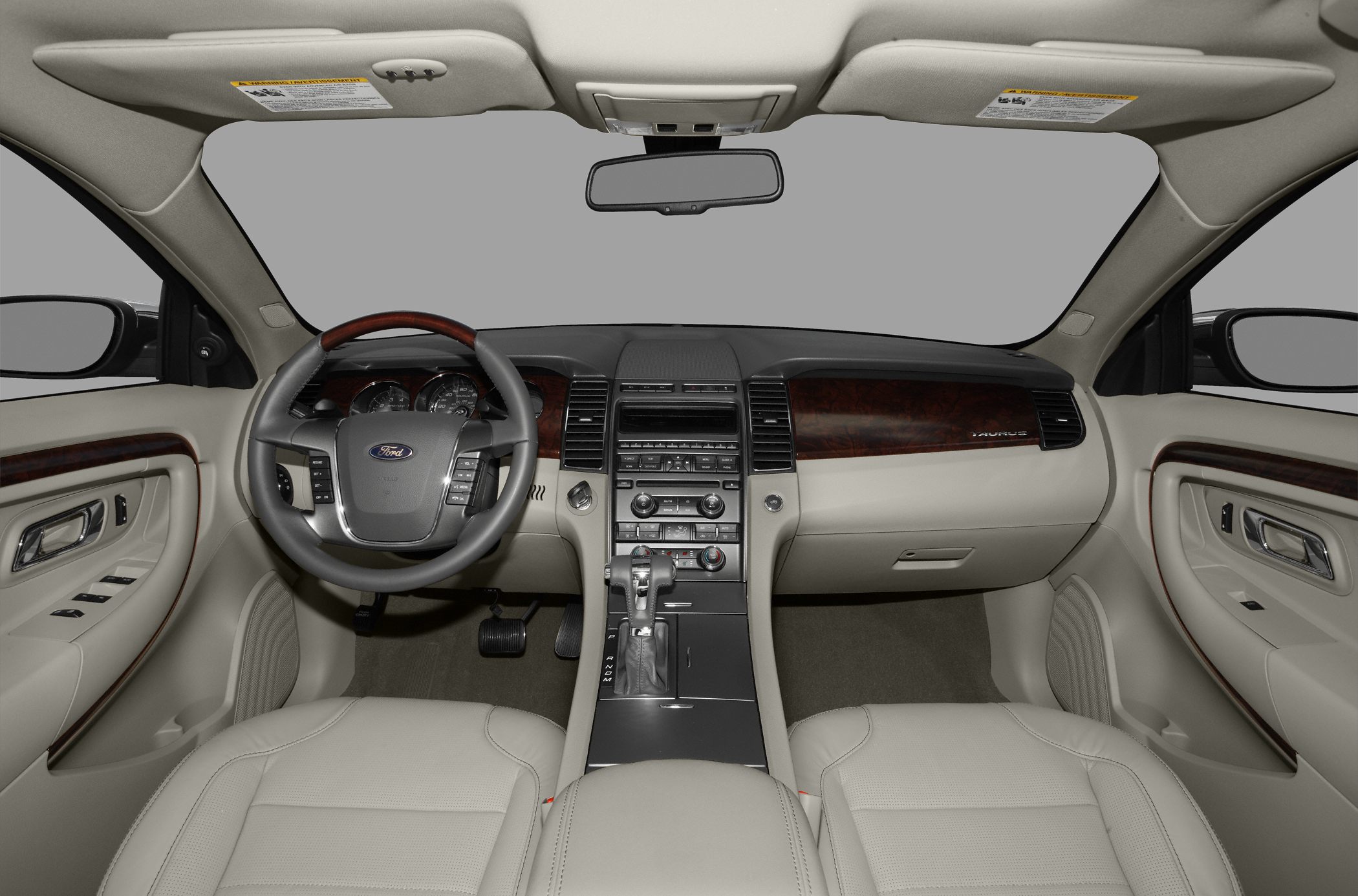 Beige leather interior with wood trim dashboard and multi-function steering wheel