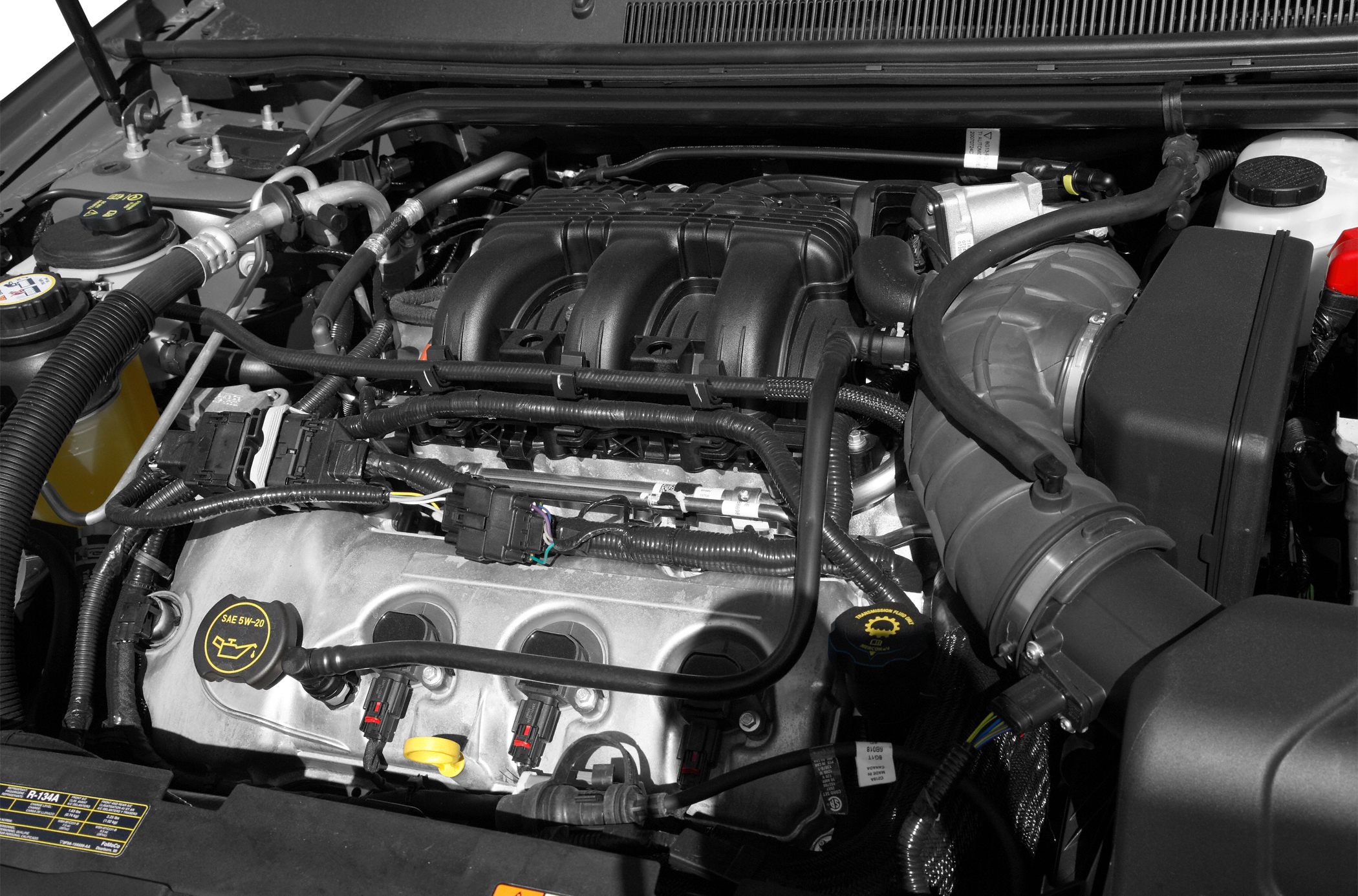 Close-up of V6 engine compartment featuring intake manifold and oil cap