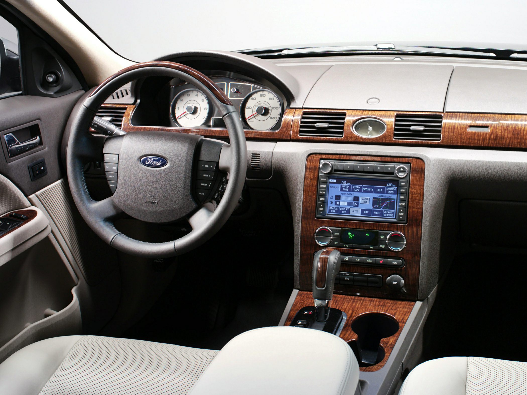 Car interior dashboard with wood trim and infotainment system