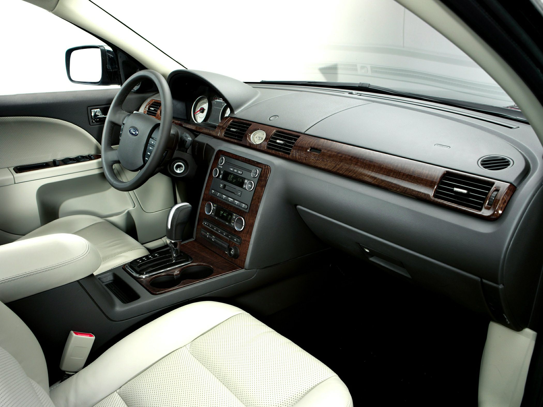 Wood trim dashboard and light leather seats in car interior