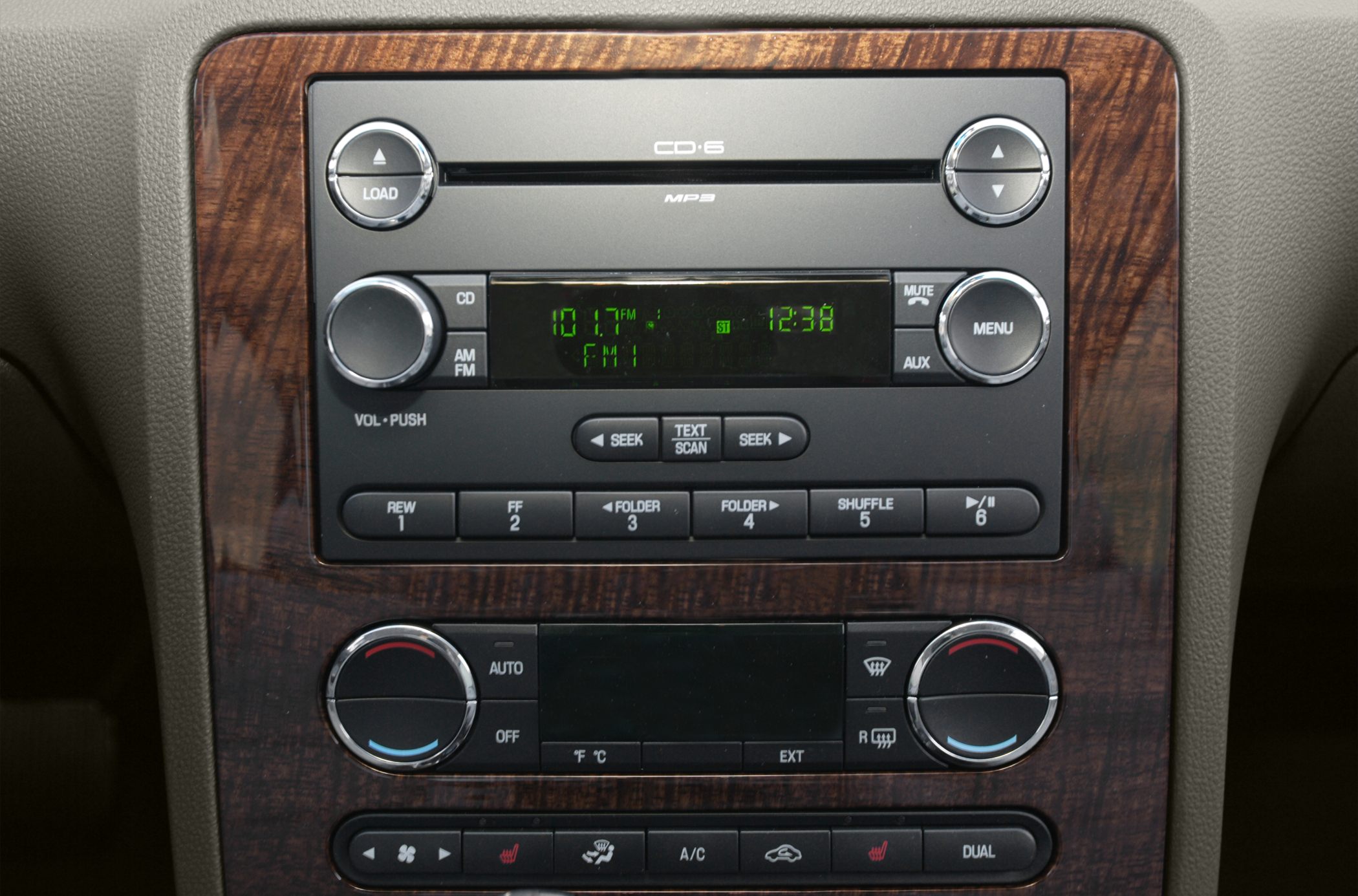 Car audio system and dual-zone climate controls with wood trim panel