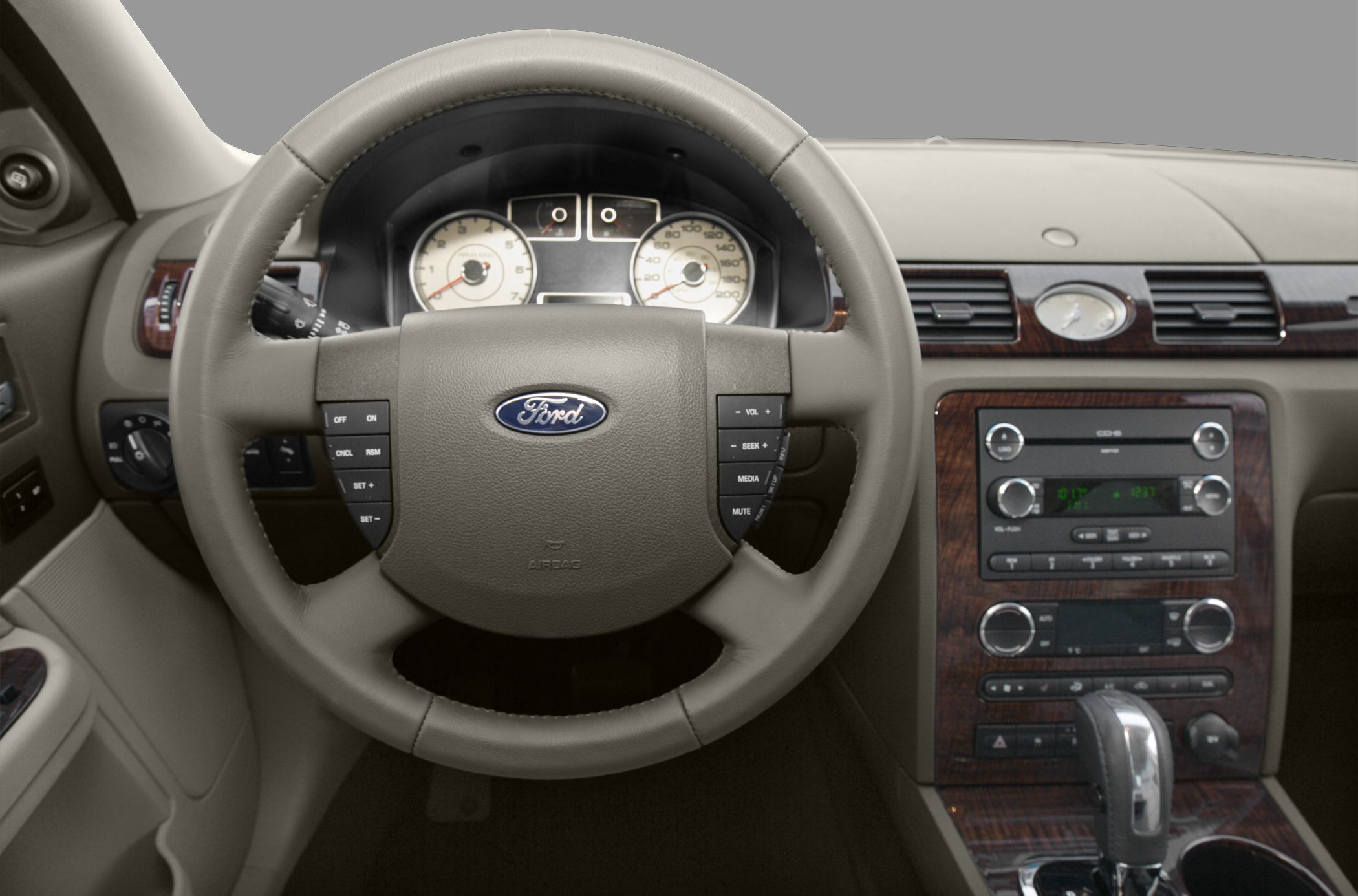 Steering wheel with controls and wood-trimmed dashboard center console