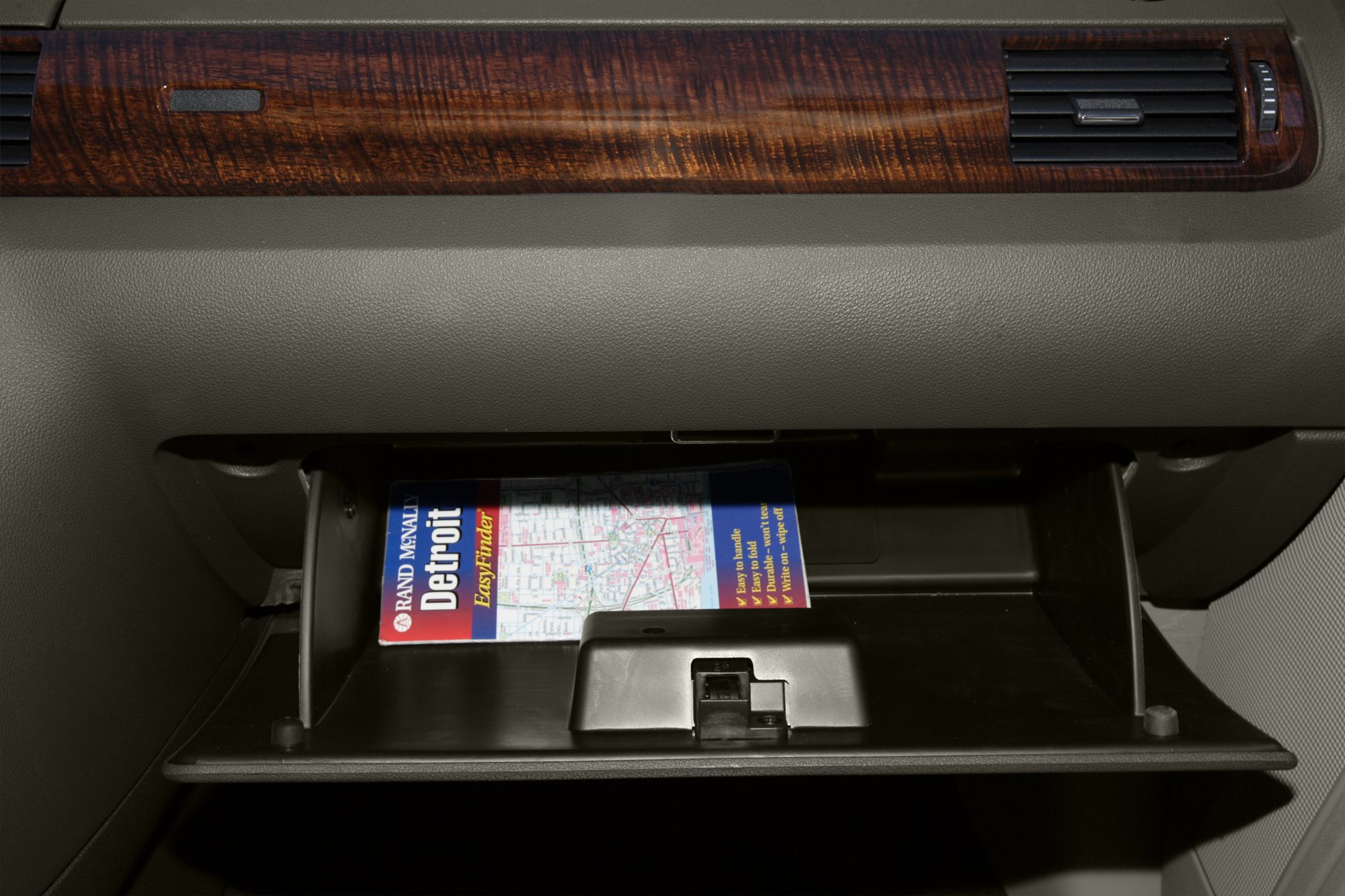 Open glove box with a Detroit map inside