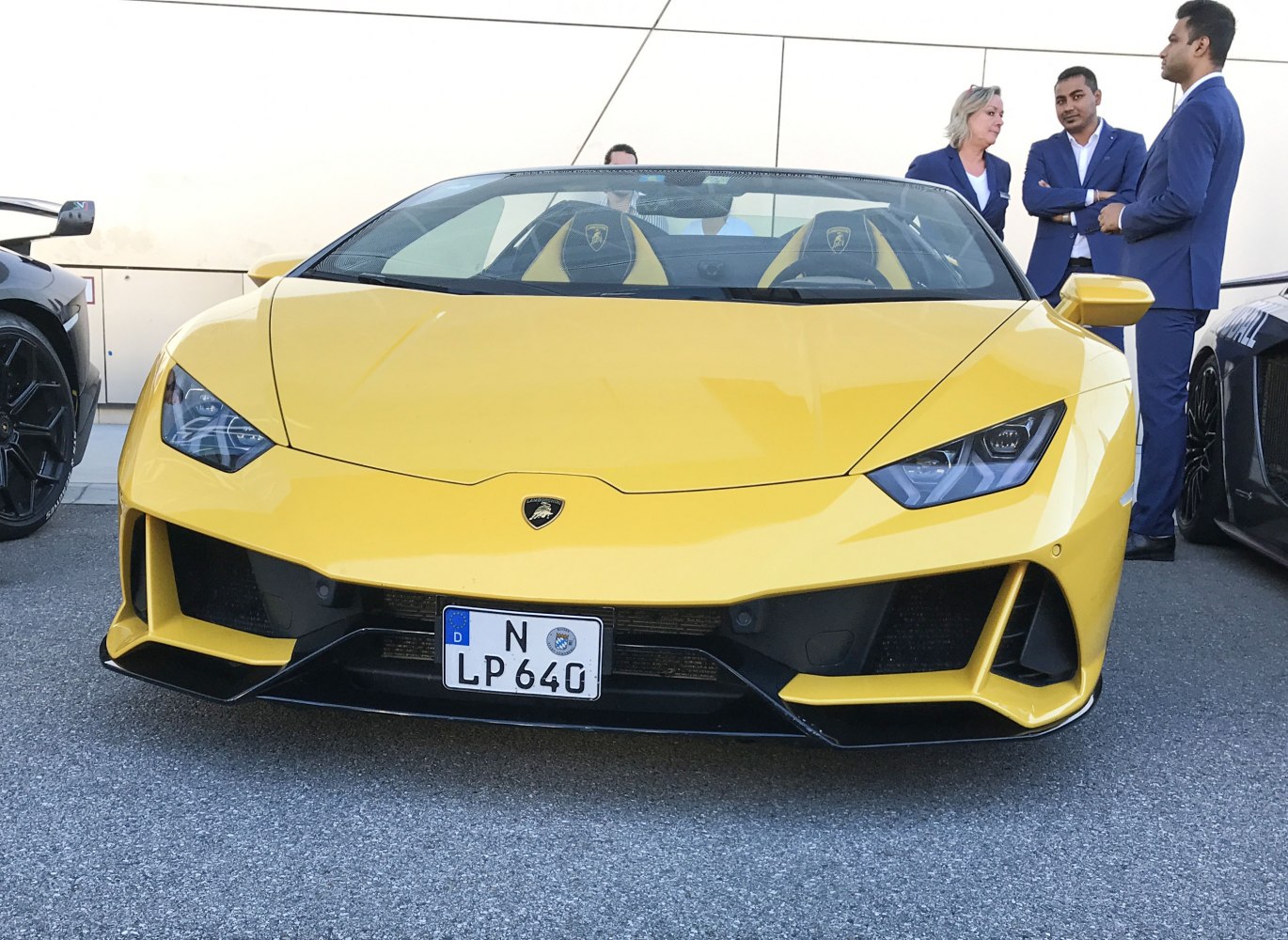 Yellow open-top sports car with angular headlights and aggressive front air intakes