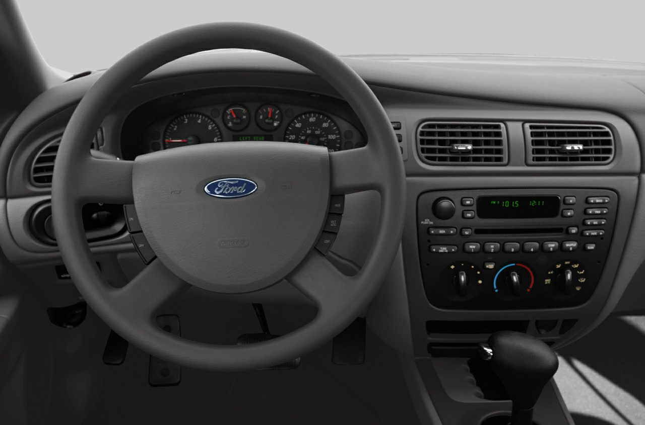 Dashboard and steering wheel with instrument cluster, radio, and climate controls.