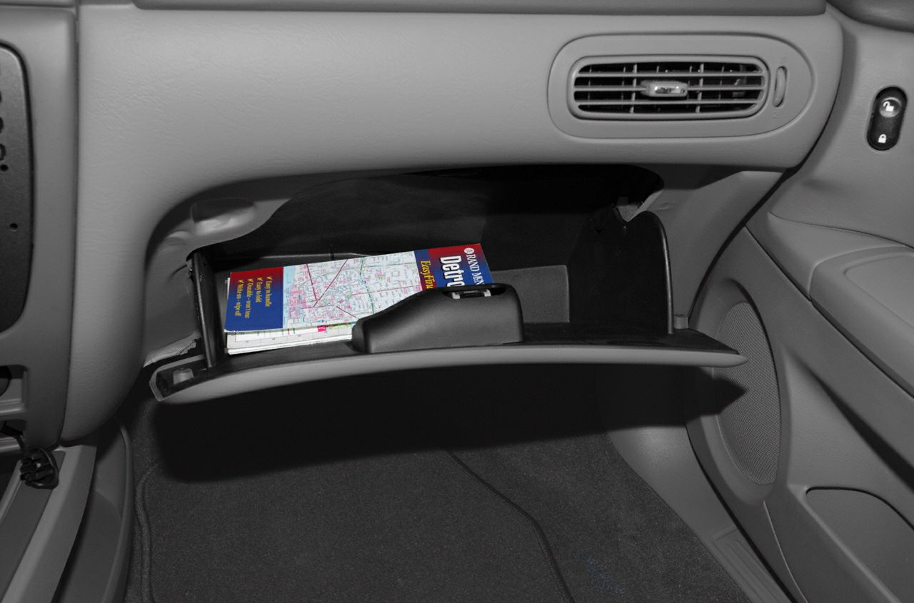 Open glove box with a map inside in car interior