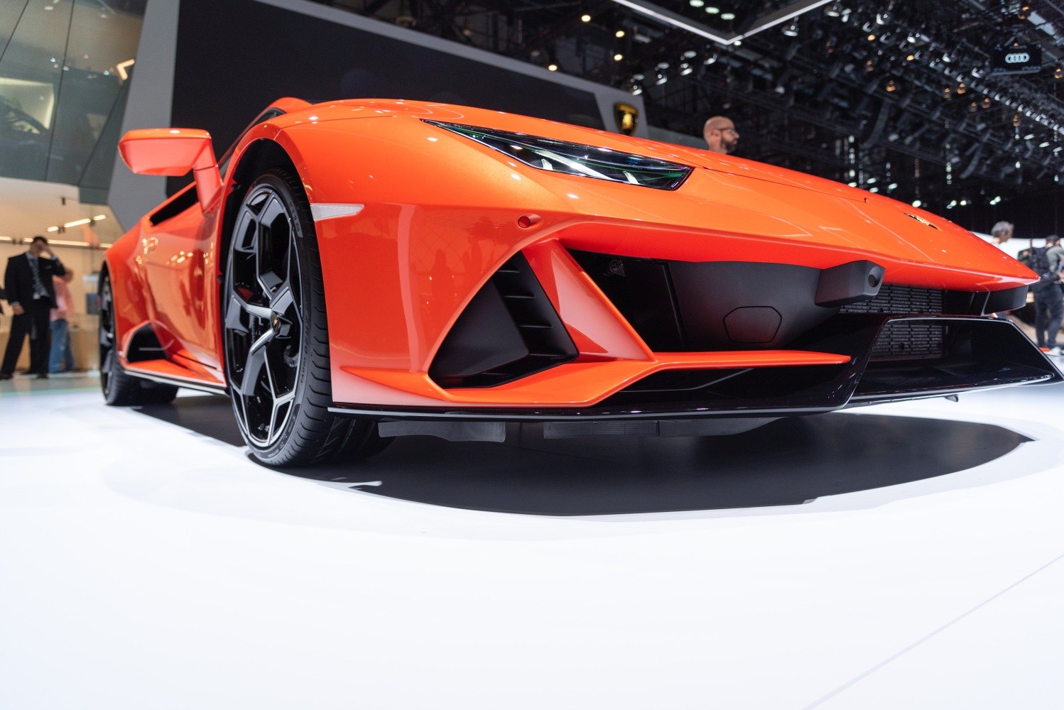 Aggressive aerodynamic front bumper and black alloy wheel close-up.