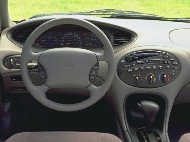 Dashboard and steering wheel with control buttons and center console layout.