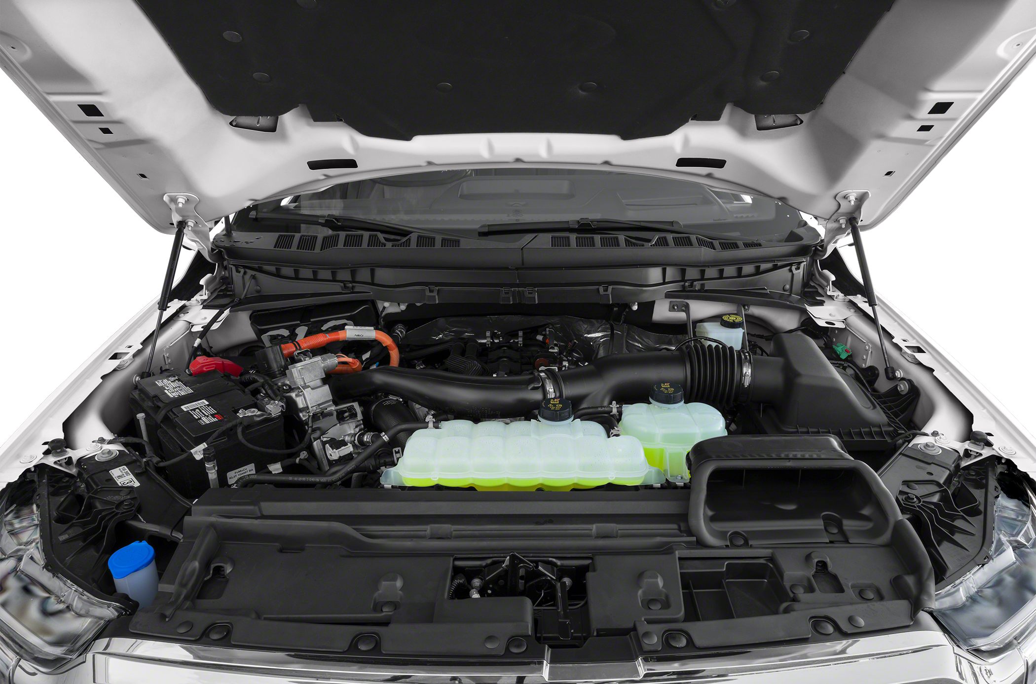 Open engine bay with fluid reservoirs, intake duct, and battery