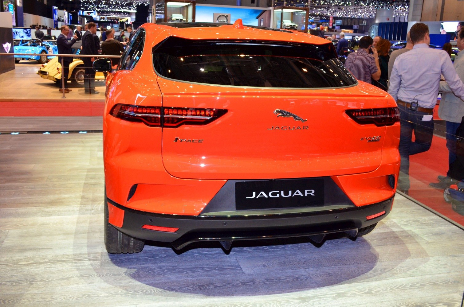 Rear view of electric SUV with sleek taillights and aerodynamic design.