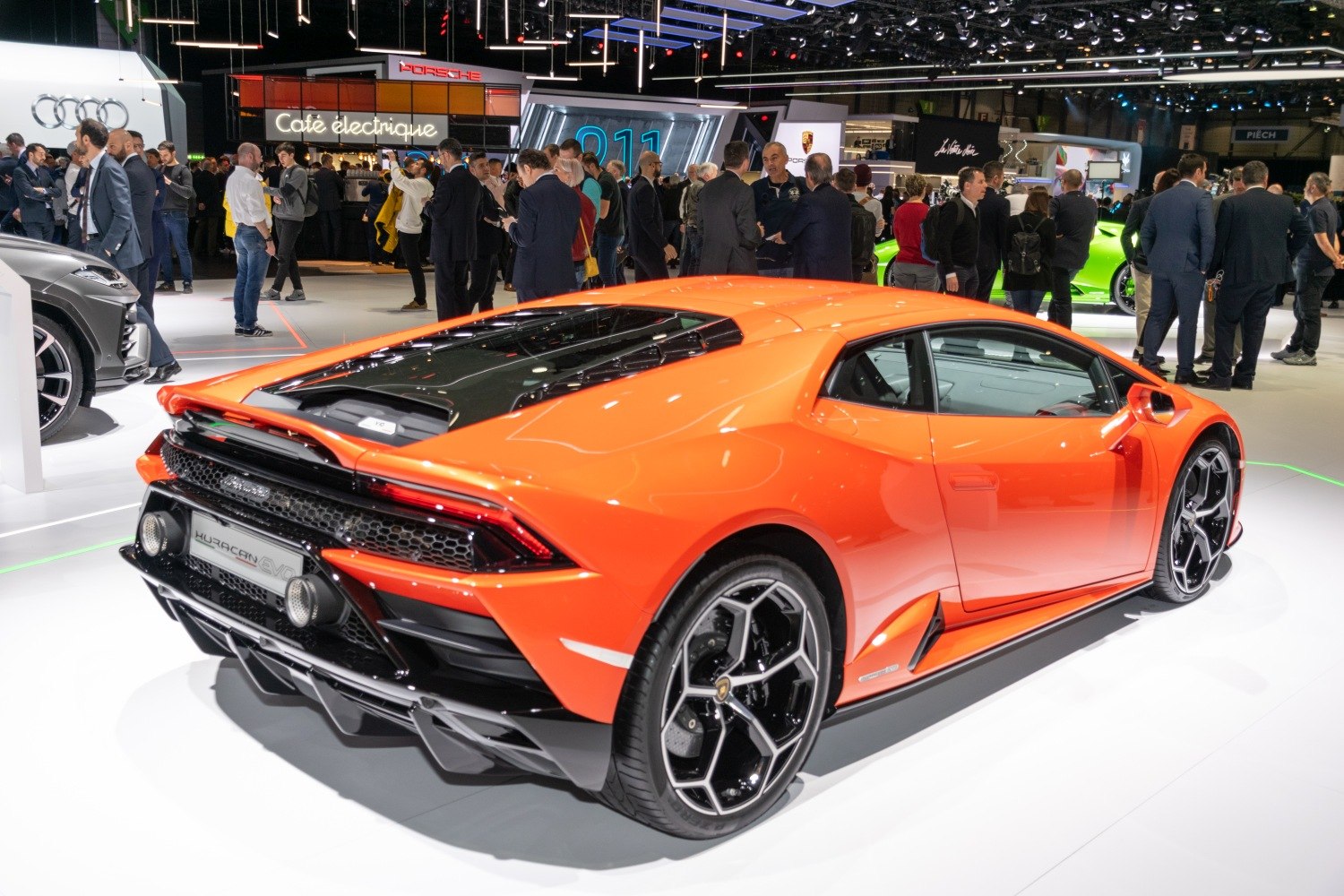 Orange supercar showing rear and side profile with distinctive alloy wheels
