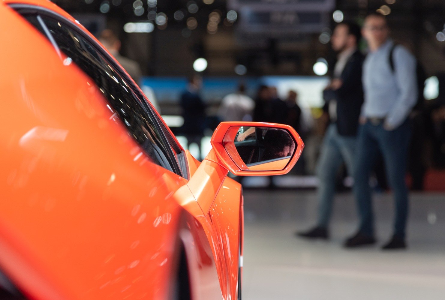 Close-up of bright orange side mirror and door exterior