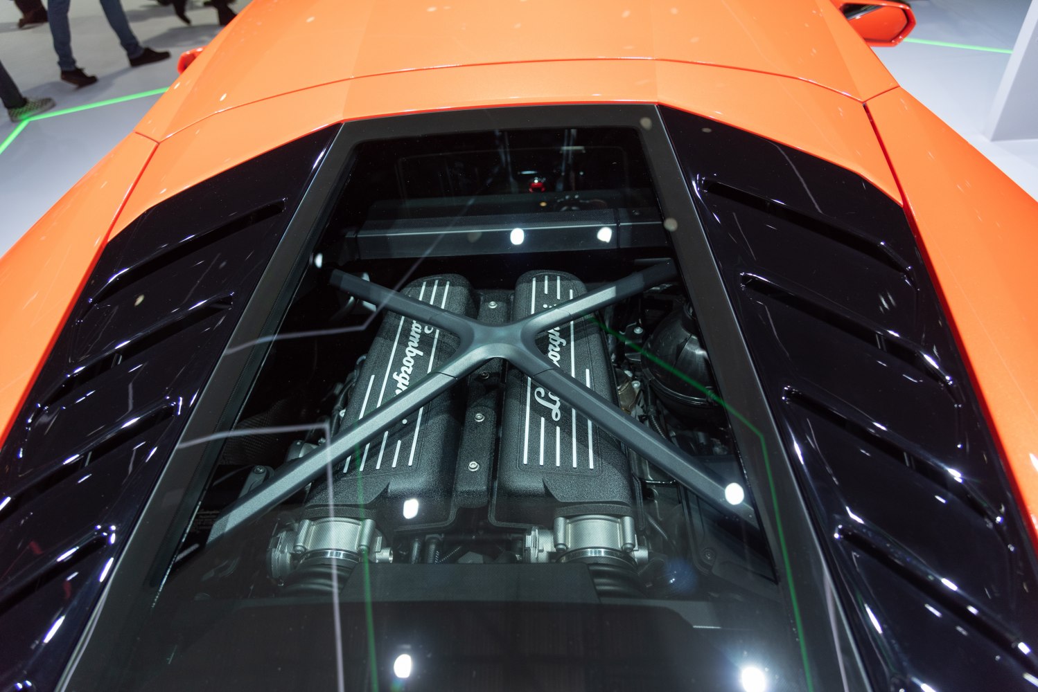 Mid-engine view through glass cover with black vented panels
