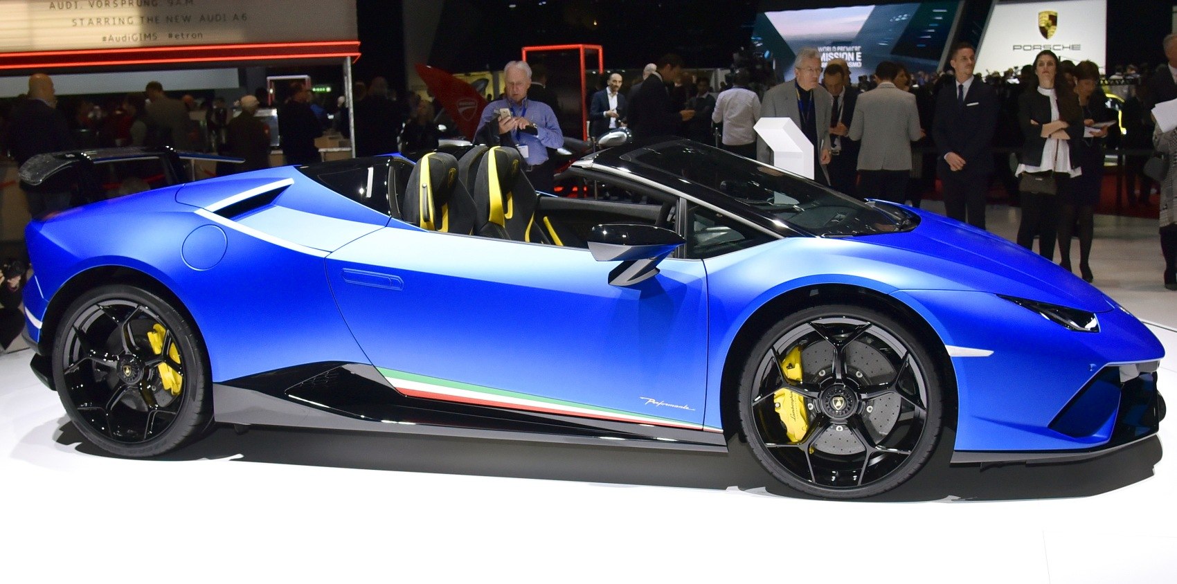 Convertible blue sports car side profile with carbon wheels and yellow calipers