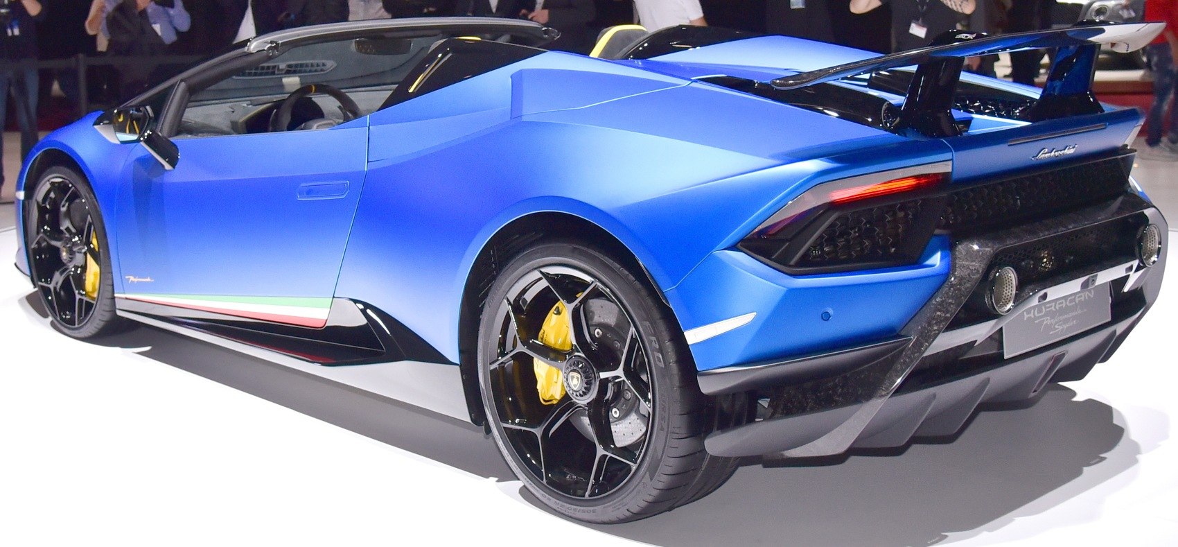 Rear three-quarter view with spoiler and black alloy wheels