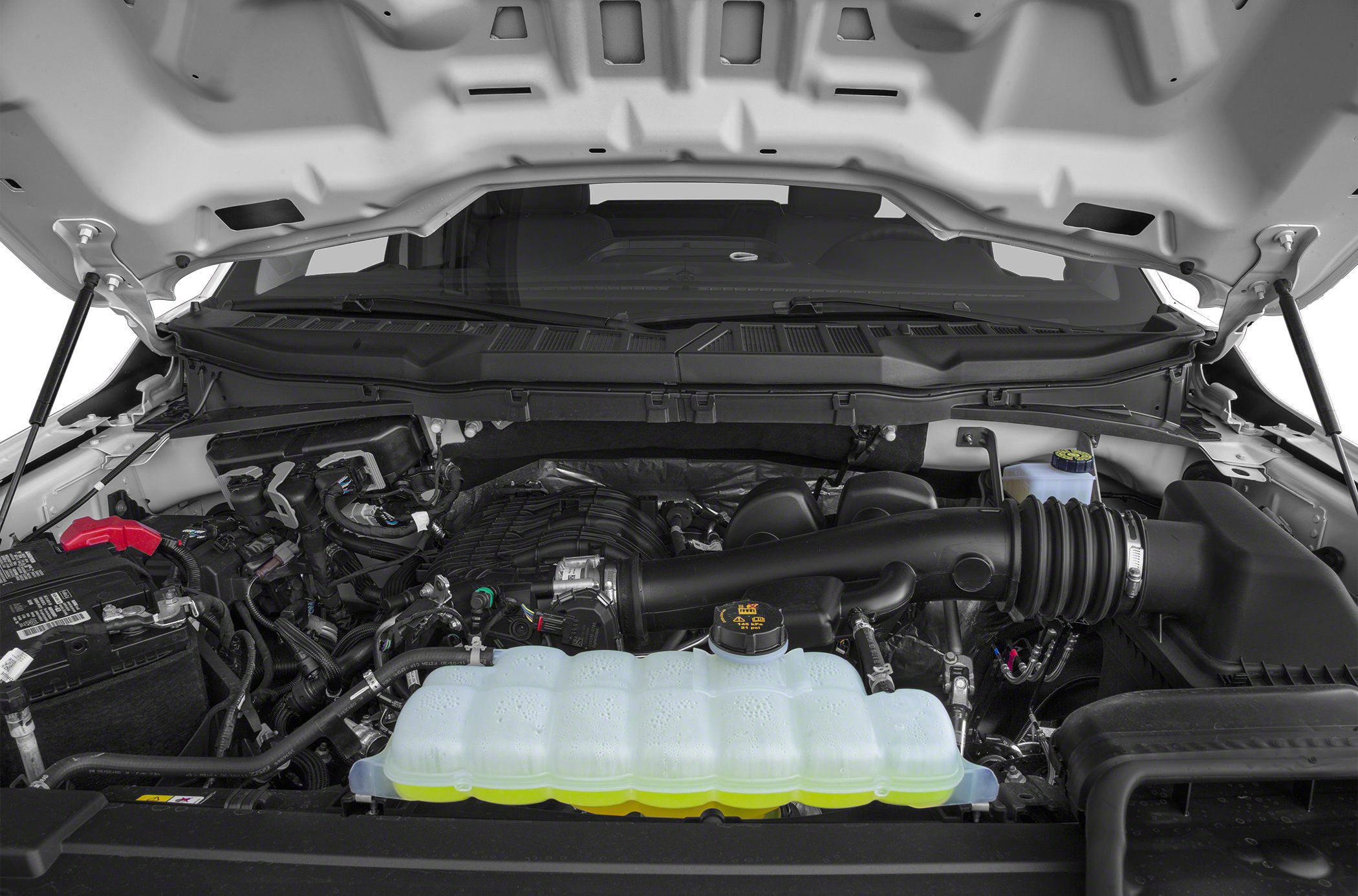 Engine bay with coolant reservoir and air intake system