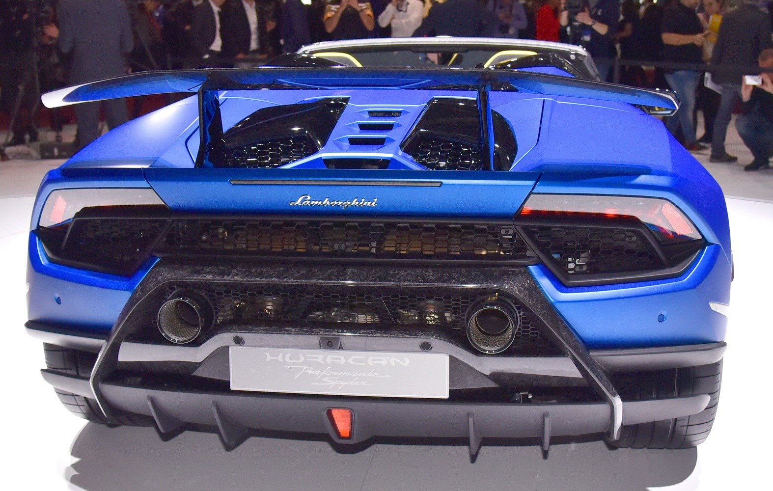 Rear view of a sports car with large spoiler and dual exhausts