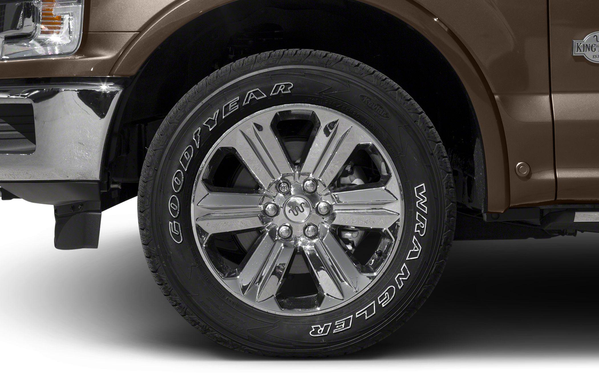Chrome alloy wheel with Goodyear Wrangler tire on pickup truck