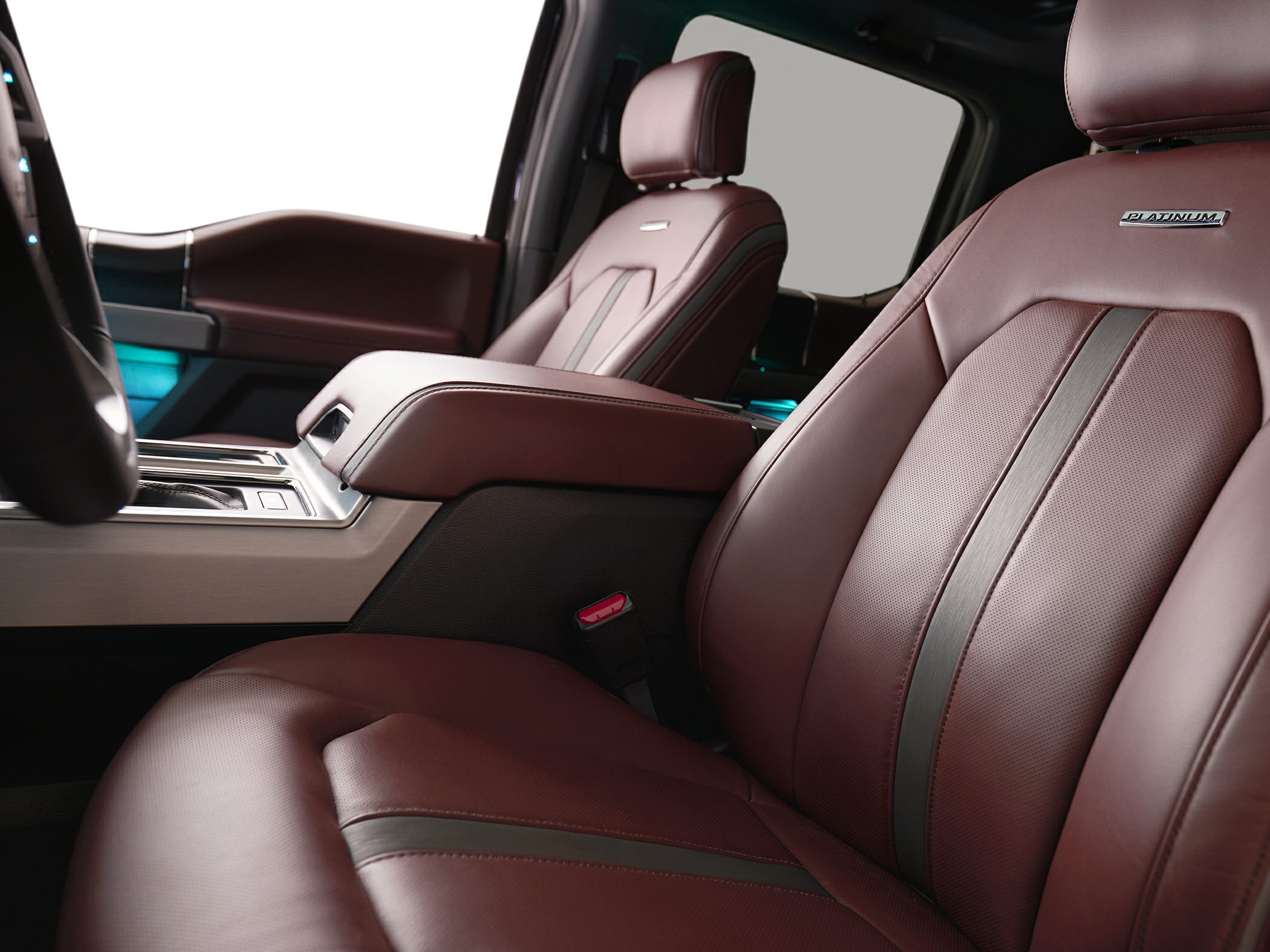 Luxury brown leather seats with center console and cabin details