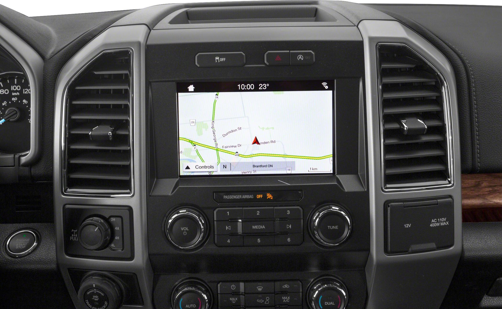 Dashboard infotainment screen with control knobs and air vents