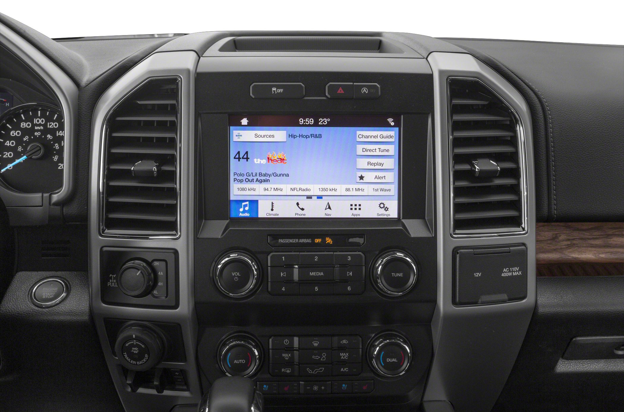 Central infotainment touchscreen, audio controls, and dual zone climate panel
