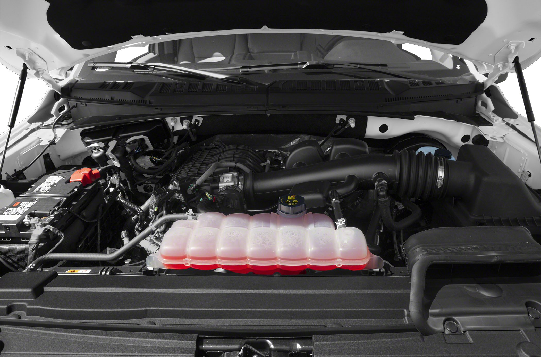 Engine compartment with cooling system reservoir and air intake components
