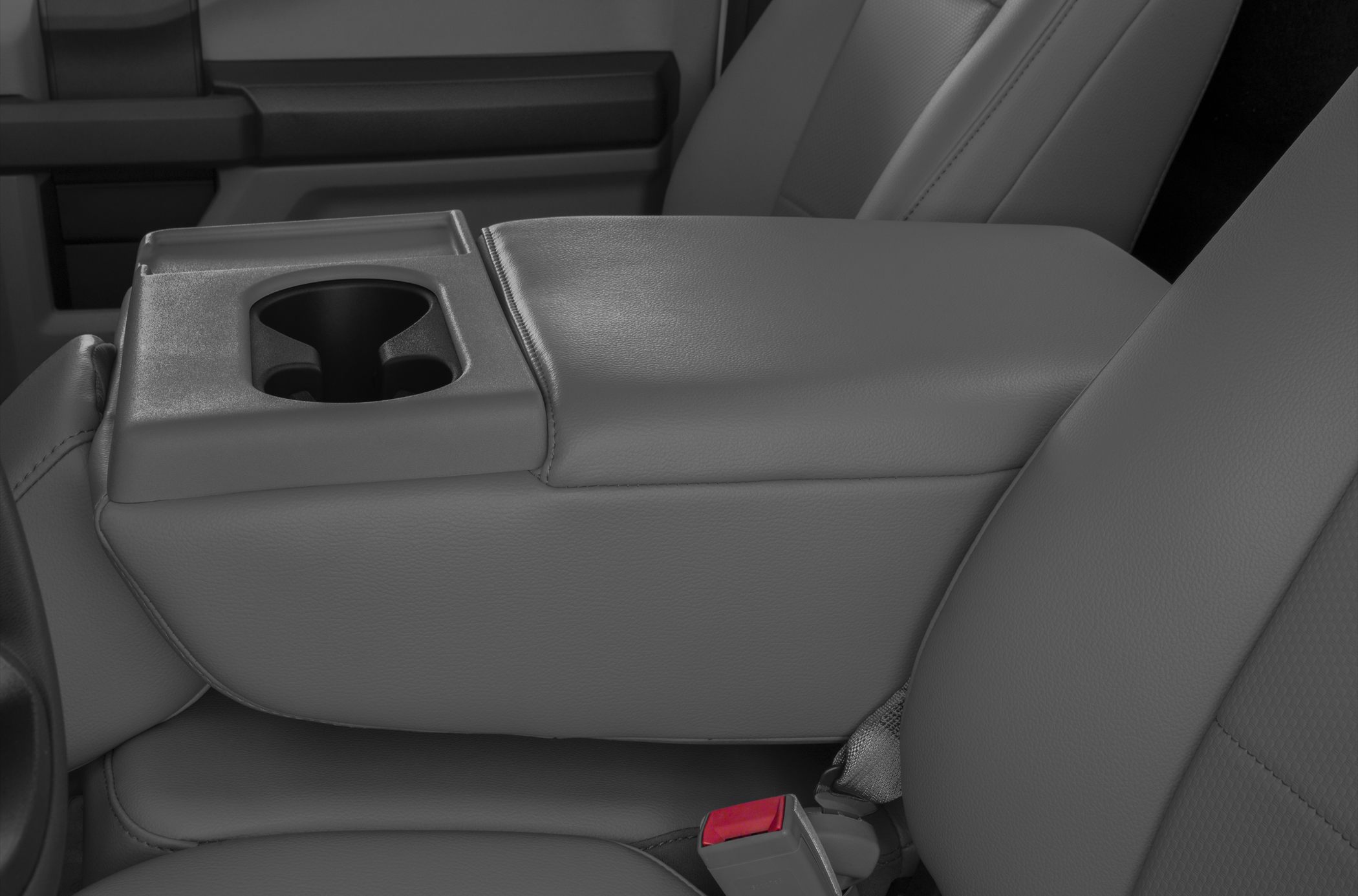 Close-up of center console with cup holder and leather seats