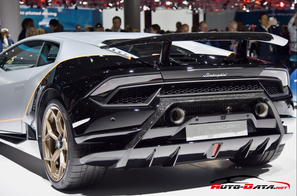 Rear view with dual exhaust, carbon fiber spoiler, gold wheels, and aerodynamic diffuser.
