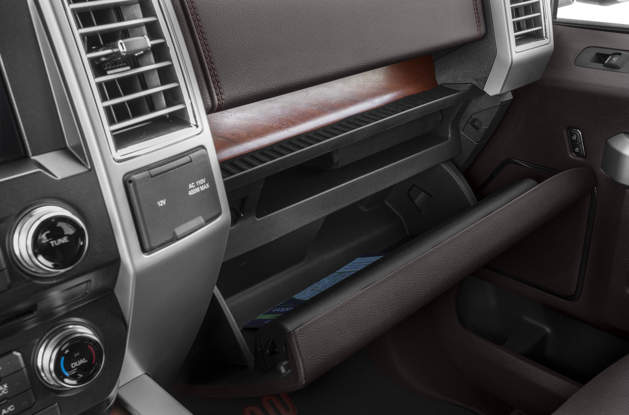 Open glovebox and dashboard controls in vehicle interior