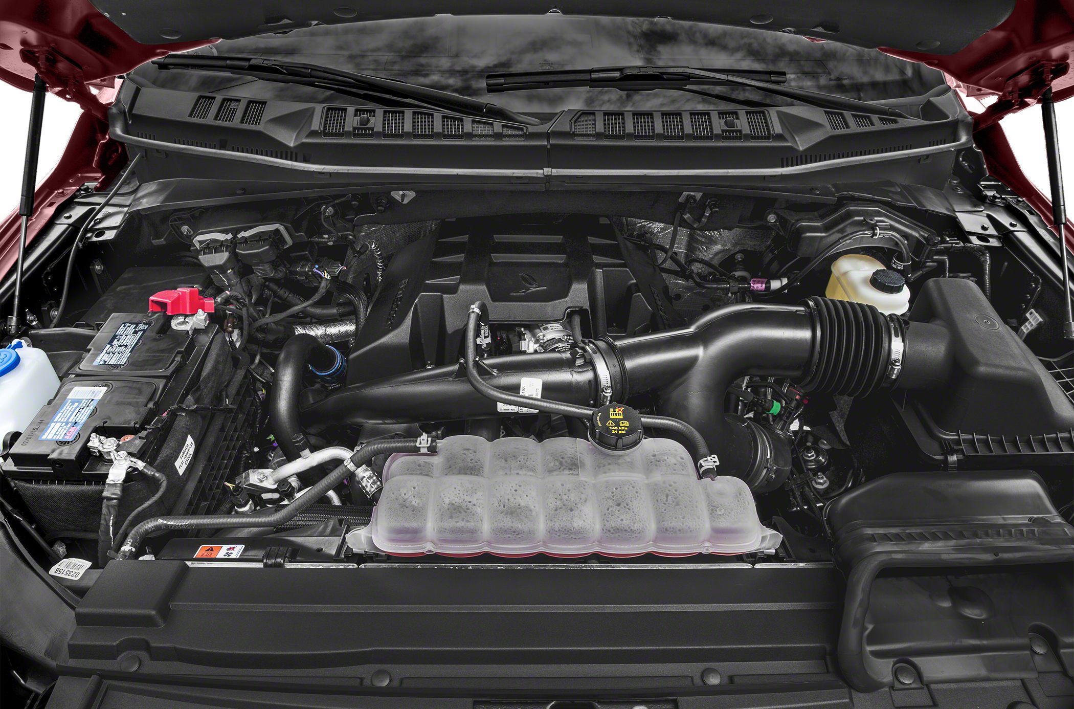 Engine bay with air intake and battery components.