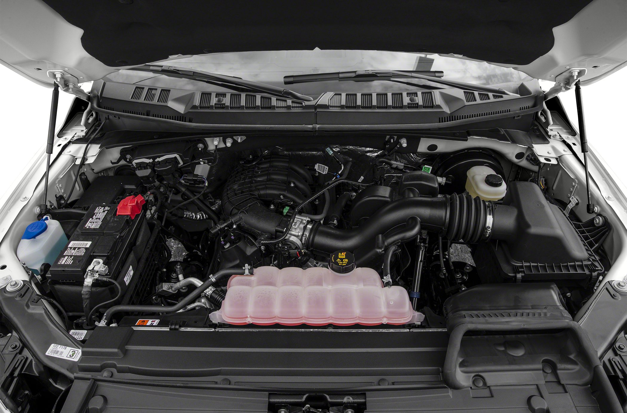 Engine compartment with battery, air intake, and fluid reservoirs