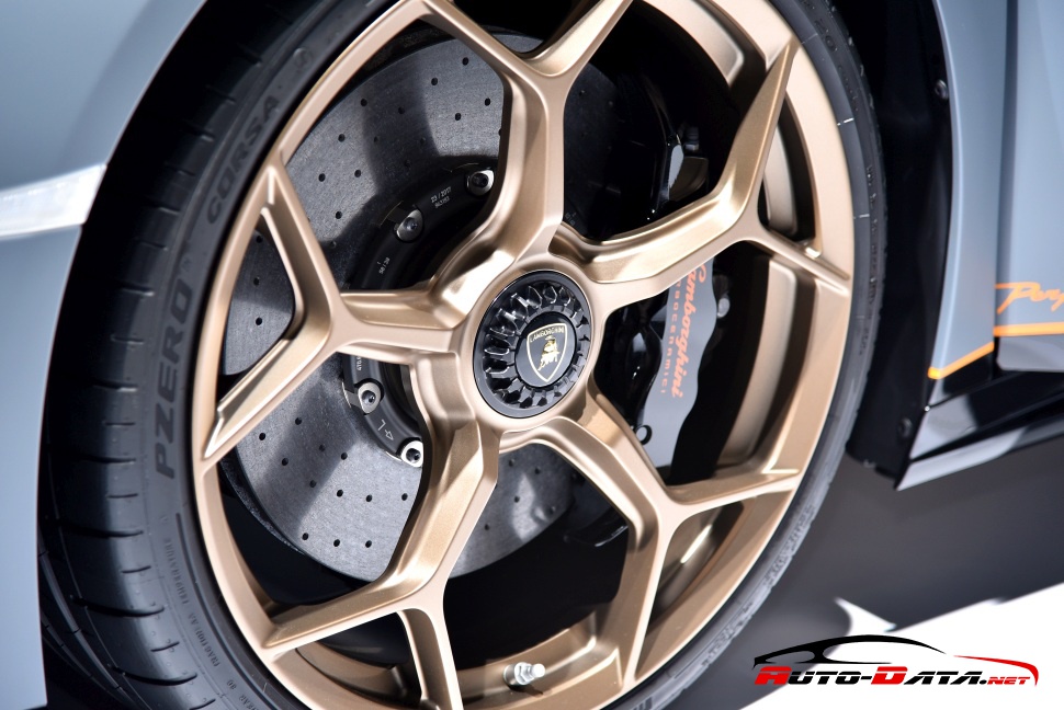 Close-up of bronze alloy rim and carbon-ceramic brake disc on a sports car wheel