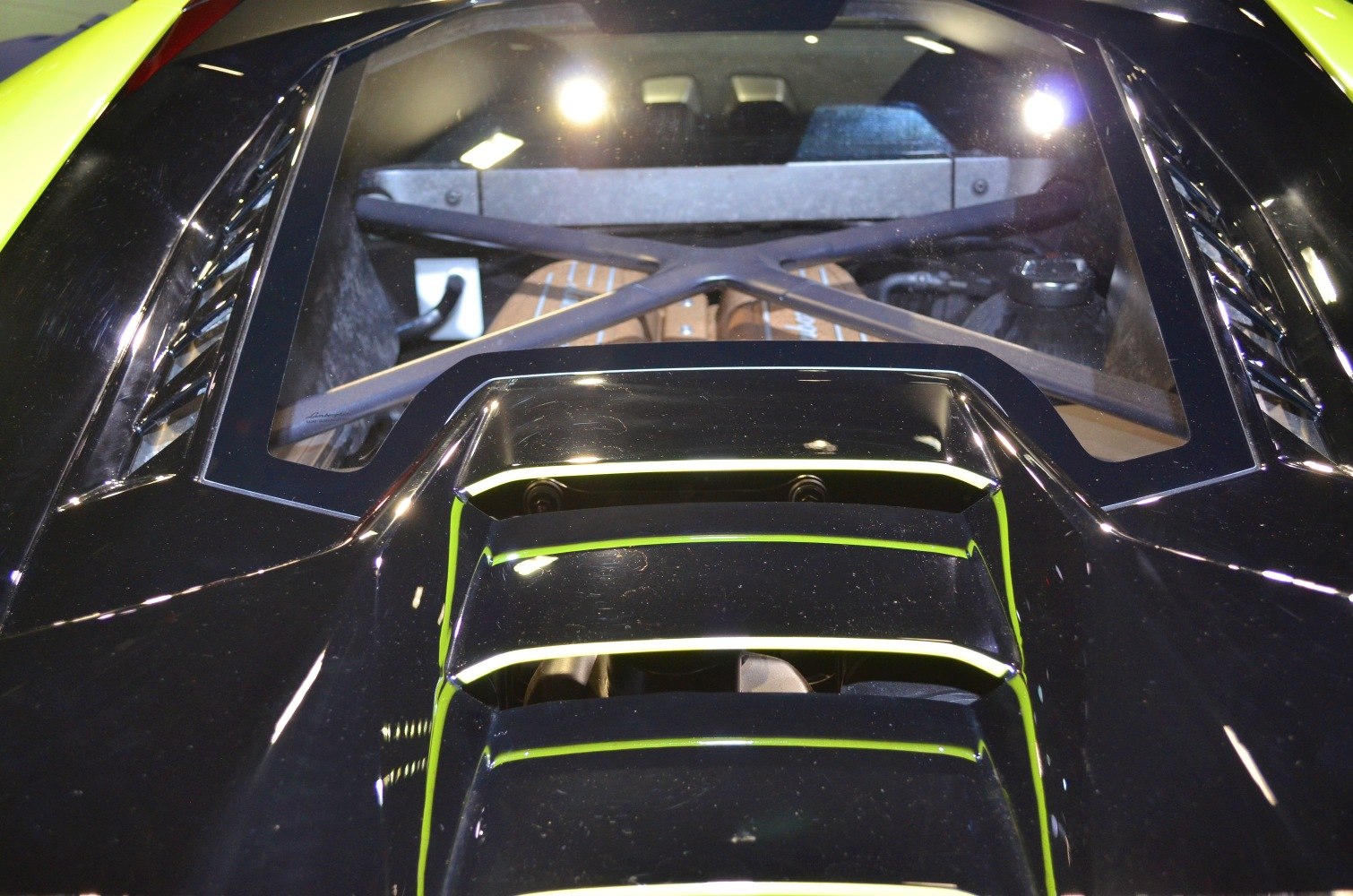 Close-up of engine bay and rear vents of a high-performance sports mid-engine vehicle.