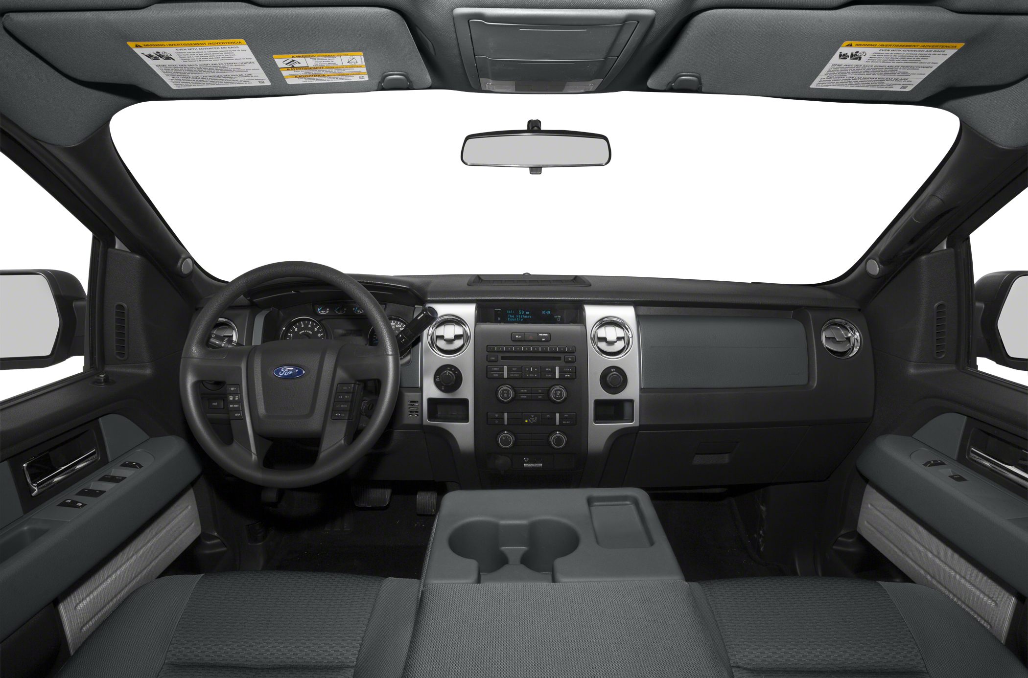 Interior view with dashboard, steering wheel and center console with cup holders.
