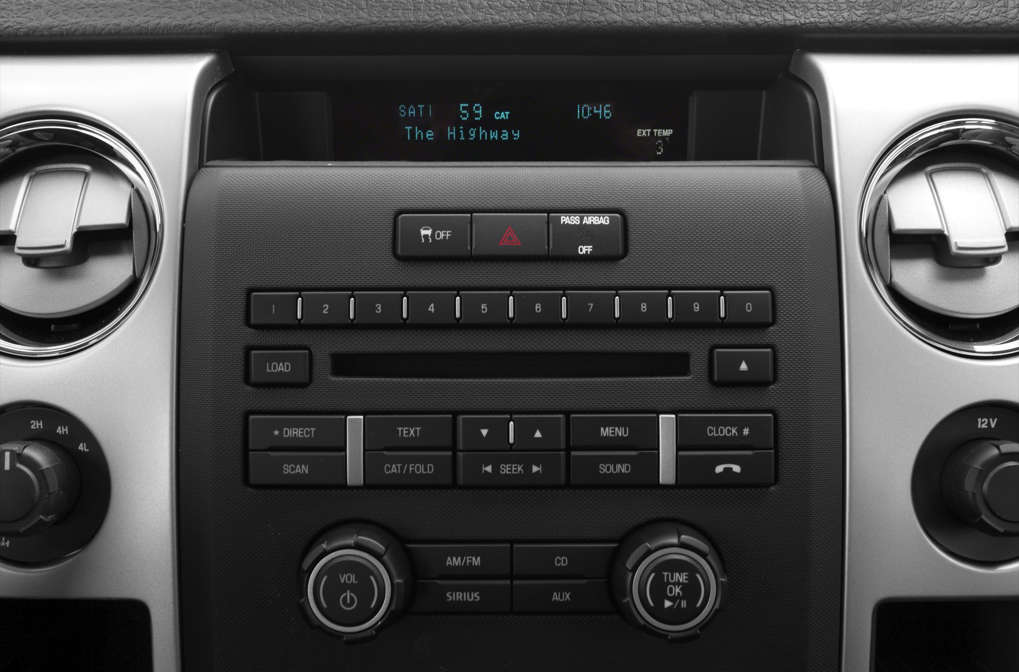Close-up of audio and climate control console with digital display and control knobs
