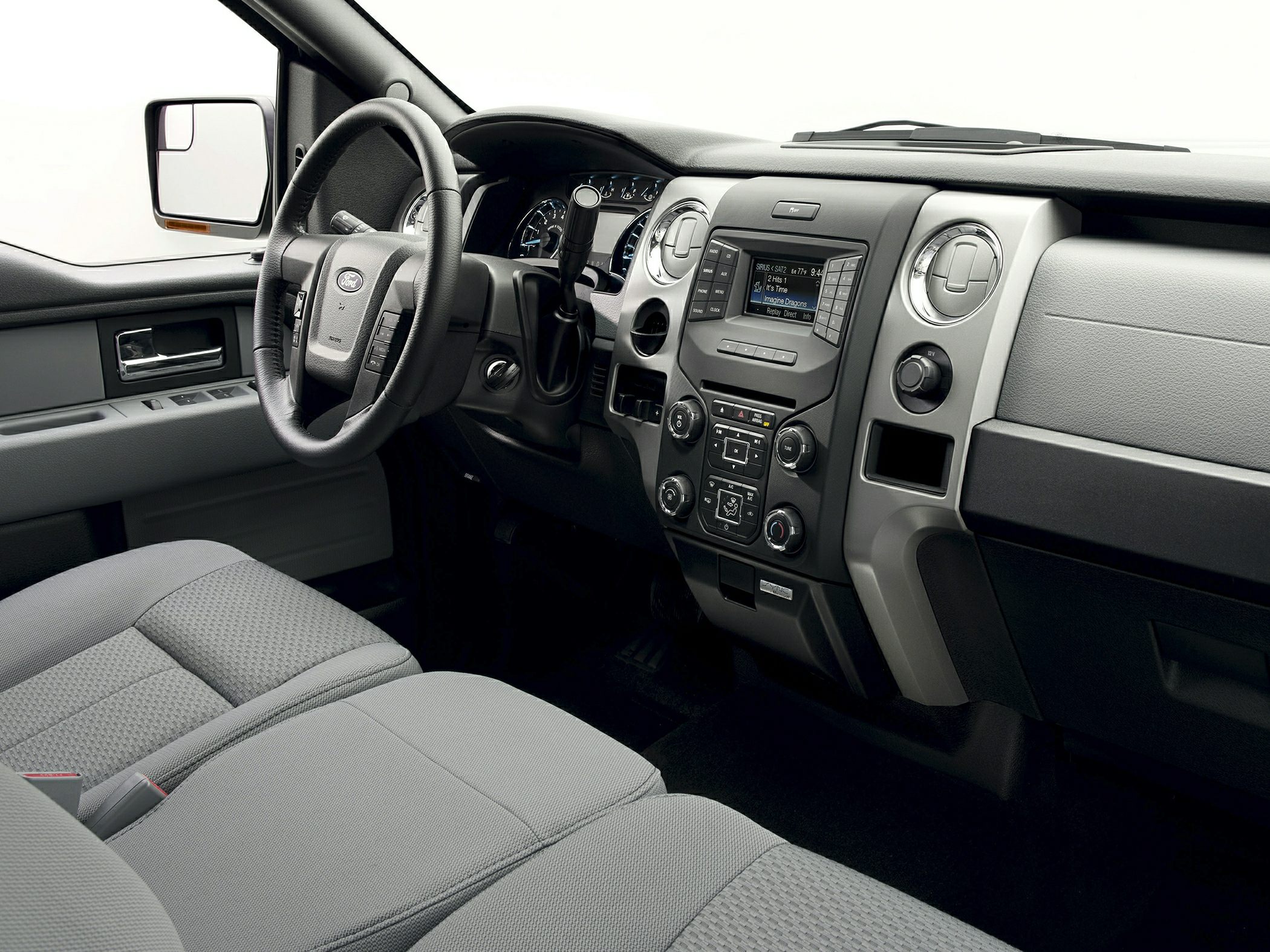 Interior dashboard and steering wheel with central control panel and fabric seats