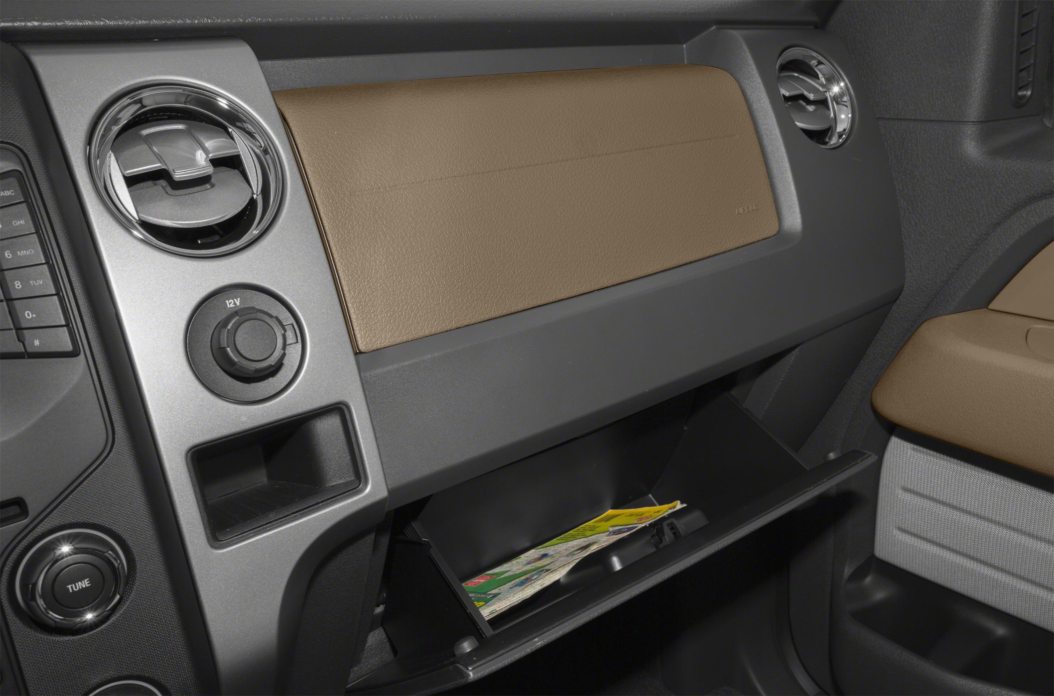 Dashboard with open glovebox and round air vents