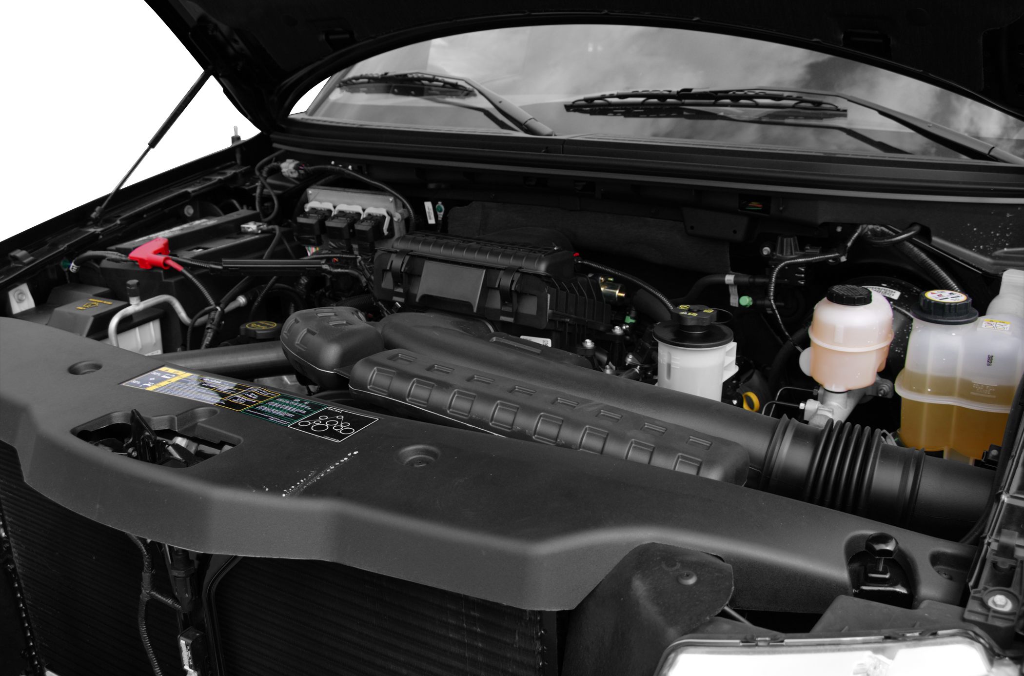 Engine compartment with visible engine cover and fluid reservoirs