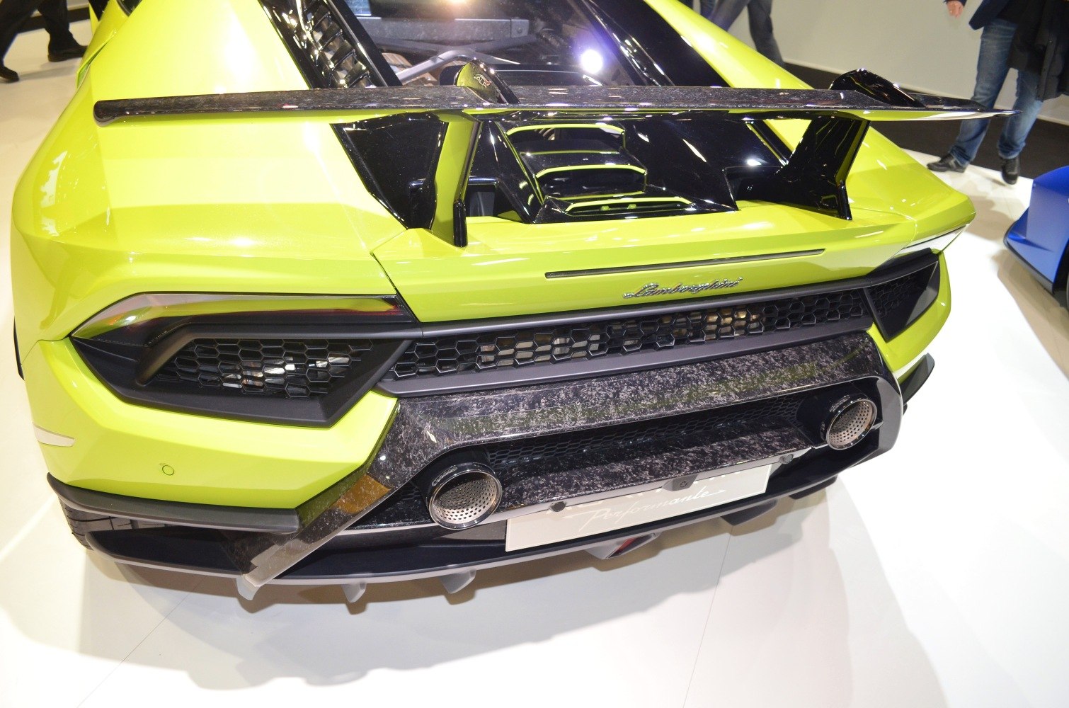 Rear view of a yellow sports car with large aero wing and dual exhaust