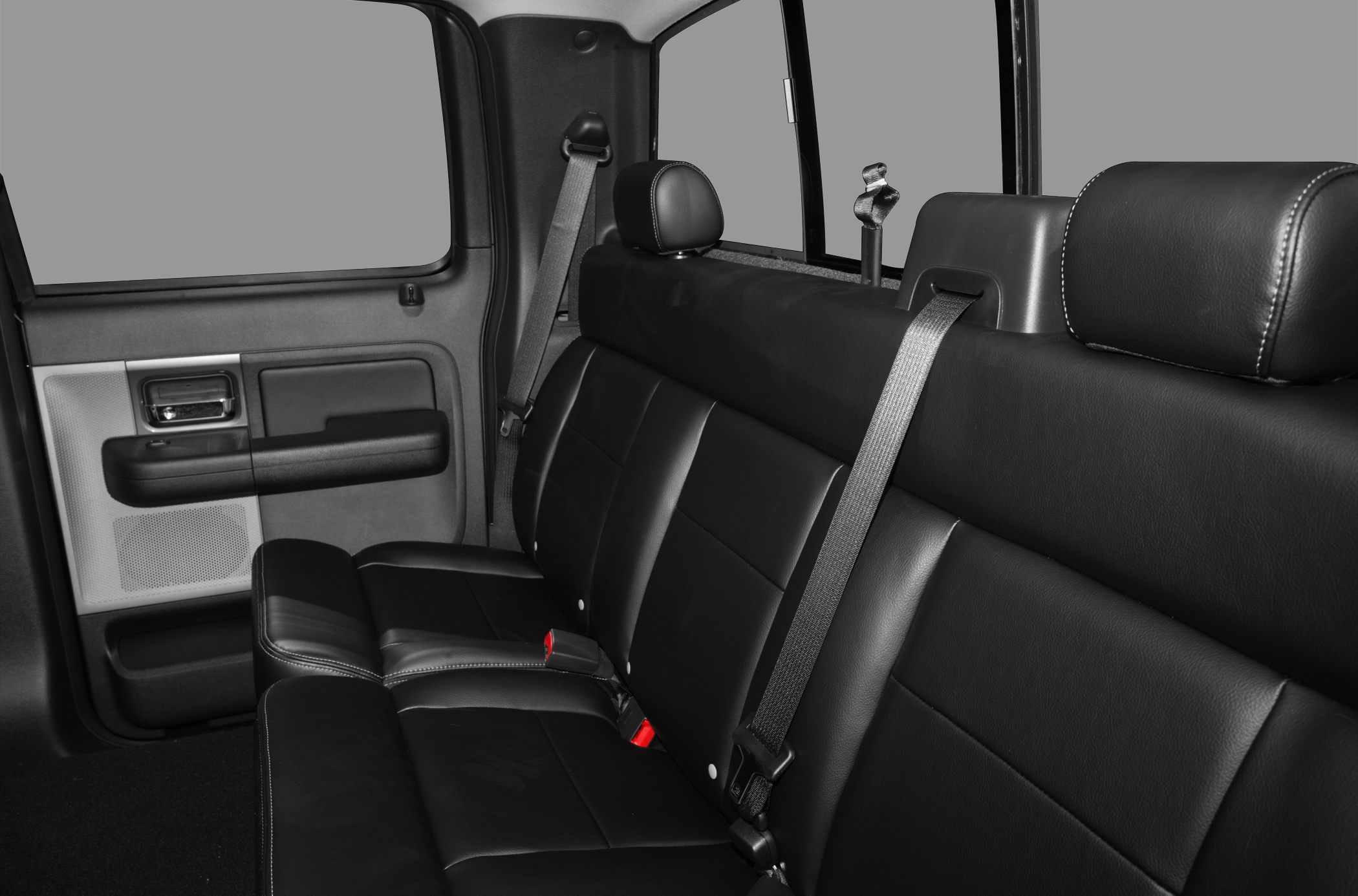 Black leather rear seats with seat belts and spacious truck interior